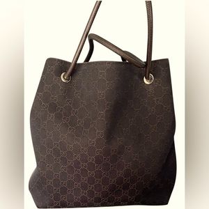 Gucci canvas tote in good condition; minor signs of wear at base corner.